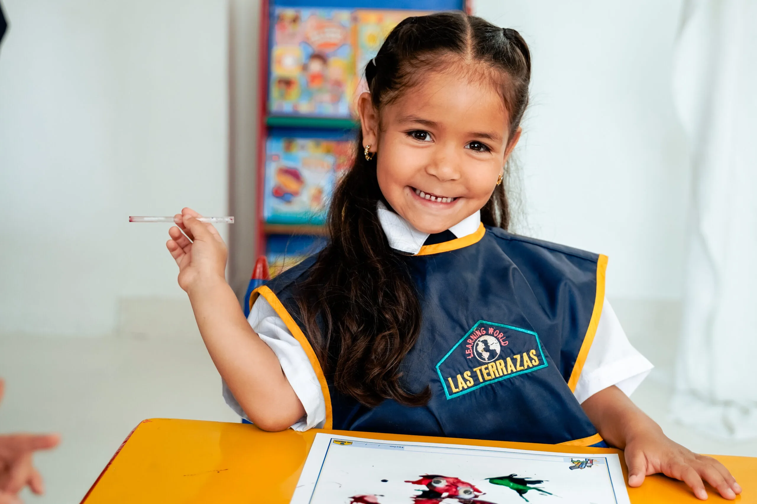 Niña sonriente realizando actividades artísticas en el Preescolar Las Terrazas